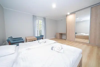 Łóżko lub łóżka w pokoju w obiekcie VacationClub - Zdrojowa 7 Apartament 3