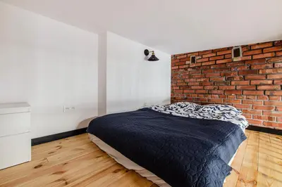 Łóżko lub łóżka w pokoju w obiekcie 9a Loft City Apartment