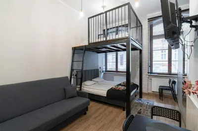 Łóżko lub łóżka w pokoju w obiekcie Apartamenty loftowe blisko Rynku